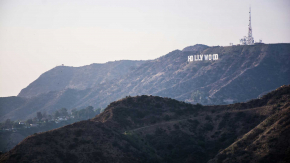 View of the Hollywood Sign from a mountain top, overlooking the city of Los Angeles