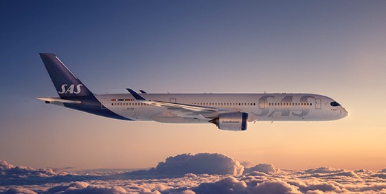 A Scandinavian Airline flight flying in the air above the clouds