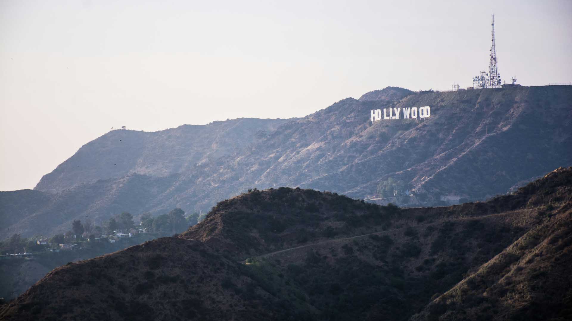 View of the Hollywood Sign from a mountain top, overlooking the city of Los Angeles